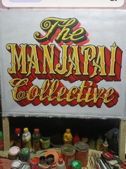 The "Manjapai Collective" sign in progress in my workshop, showing the base colors and lettering before the final details were added.