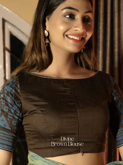 From fashion files to festive feels, this divine brown blouse with printed sleeves brings both. The boat neck and front zipper make it a comfortable and stylish choice.