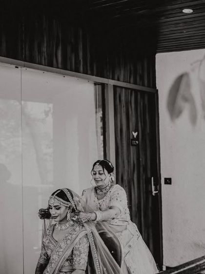 A mother helping her daughter get ready. These quiet, behind-the-scenes moments are just as important as the main ceremony.
