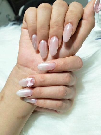 Another view of the beautiful pearlescent pink manicure, perfect for a dreamy and feminine style.