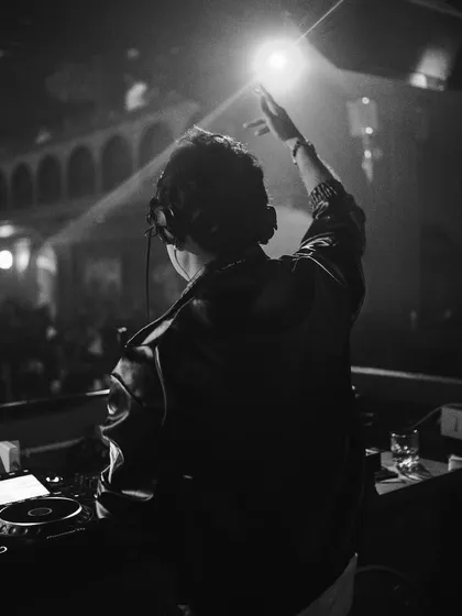 A black and white shot of me at the decks at Hashtag, reaching out to the crowd.