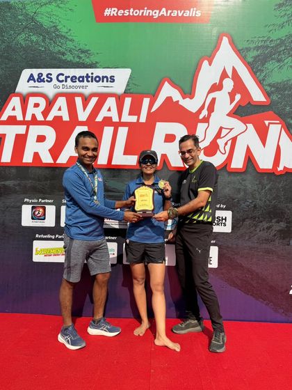 A winner receiving her trophy on stage. We ensure every winner gets their moment of recognition.