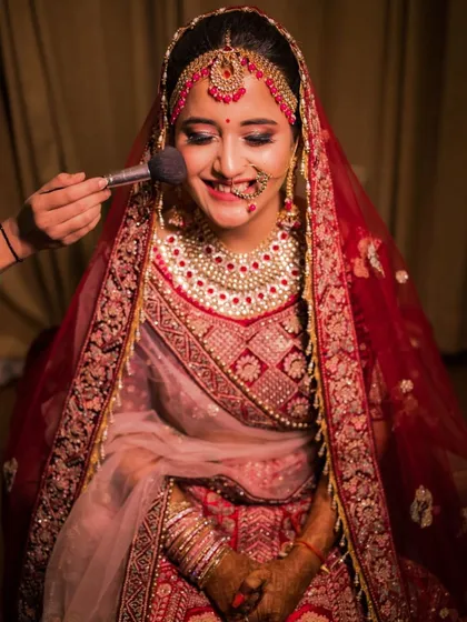 A happy, candid moment while applying the finishing touches. This bride from Indore was an absolute joy, and her smile says it all. The makeup is designed to look great even up close.