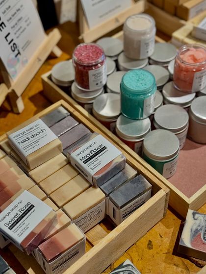 We love how the colors of our products, like the Rose-tic Charm salt soak and Crisp Cucumber body polish, pop on our display table.