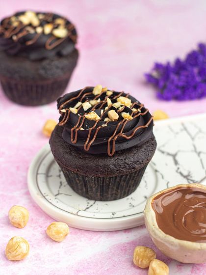 My Nutella hazelnut cupcakes are pure indulgence. A rich chocolate cupcake topped with Nutella frosting and crunchy hazelnuts.