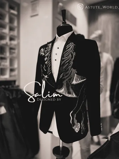 Another angle of the black tuxedo jacket with wing-like embroidery. This piece is perfect for someone who wants a touch of dark romance in their formal wear.