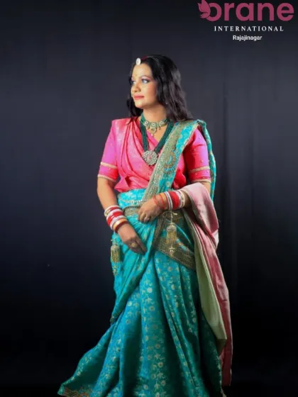 This image showcases a complete traditional bridal look, with hair styled to accommodate the saree and jewelry. Our courses cover how to create cohesive and culturally appropriate looks for brides.