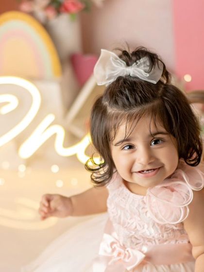 A pretty princess, so energetic and sweet. Her smile lights up this entire colorful first birthday setup.