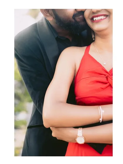 A tender moment from a post-wedding shoot, capturing a gentle kiss and a bright smile.