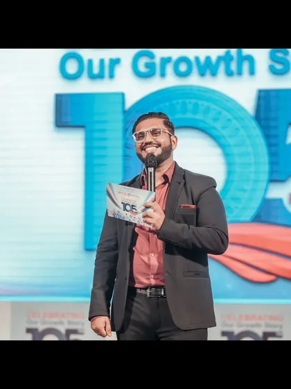 A smile is the best accessory on stage. This was captured during a corporate foundation day, where my goal was to keep the mood celebratory and engaging for everyone attending.