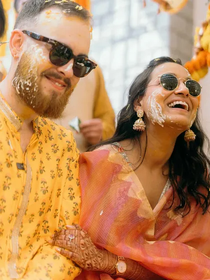 The Haldi ceremony is all about vibrant color and unrestrained fun. Ben and Shrutika, covered in turmeric and happiness, share a laugh that is completely genuine and infectious. These are the real moments.