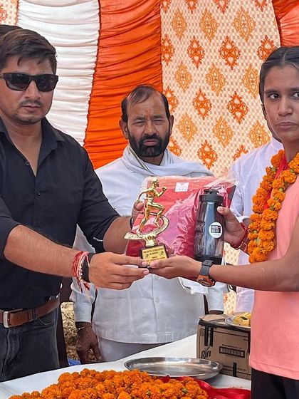 Presenting an award to one of our winning athletes at a local athletics tournament. We celebrate every victory, big or small.