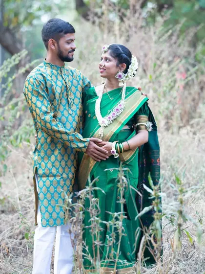 A loving couple's portrait during their baby shower festivities. Dressed in beautiful traditional attire, their shared glance is full of love and excitement for their baby's arrival.