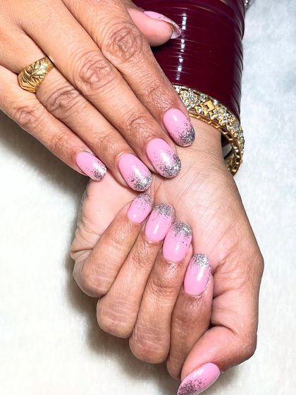 Sparkling through life, one glitter tip at a time. This design features a soft pink base with a beautiful silver glitter gradient on the tips.