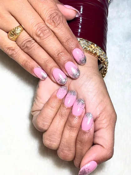 Sparkling through life, one glitter tip at a time. This design features a soft pink base with a beautiful silver glitter gradient on the tips.