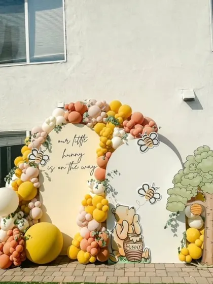 The complete Winnie the Pooh setup with character cutouts, a tree prop, and bee details, creating an immersive Hundred Acre Wood experience.