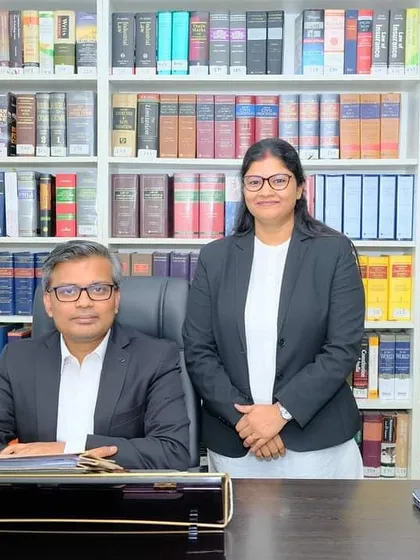 In my office with my colleague, ready for the new year. A well-organized library and a dedicated team are crucial for success in litigation.