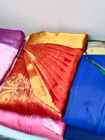 A collection of sarees, all pleated, box-folded, and ready to make draping easy for my client.