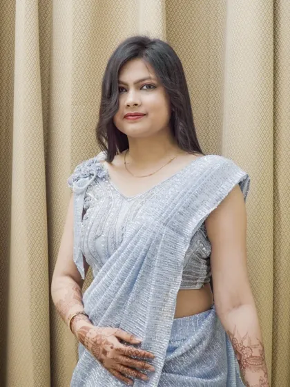 A three-quarter view of the model in the silver saree, showing how the fabric drapes. This is a classic pose for saree photography.