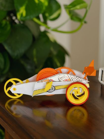 Our wind-up car, fully assembled and decorated, ready to race across the living room floor.