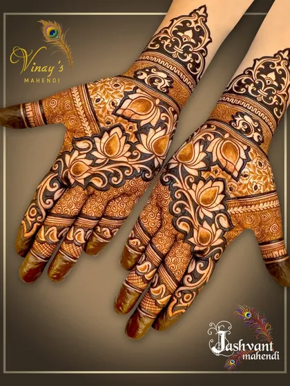 A bold, floral design covering the palms with large lotus motifs. The dark shading makes the pattern stand out.