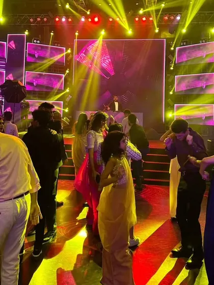 The party in full swing at a wedding in Kolkata. The combination of yellow and red lights with a vibrant LED backdrop kept the energy high.