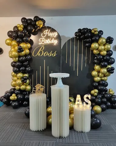 I also create custom setups for celebrating important milestones in the office, like a boss's birthday. This black and gold theme features a personalized neon sign, a stylish backdrop, and elegant balloon arches to create a sophisticated and memorable celebration spot.