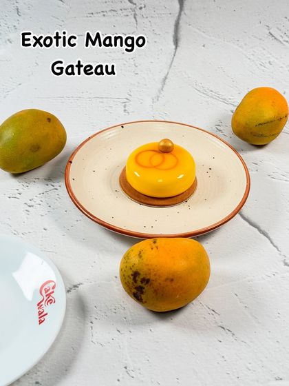Experience elegance with our Exotic Mango Gateau. This stunning dessert features a smooth mango mousse with a surprise center, all on a delicate base, making it a true showstopper.