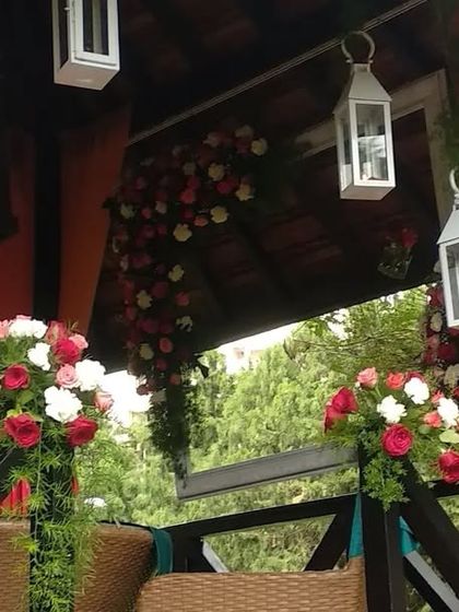 A closer look at the gazebo decor, showing the hanging white lanterns and the lush floral garlands that add a touch of elegance.