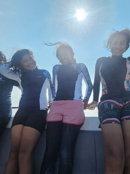 Wind in their hair and smiles on their faces. These young adventurers are enjoying the boat ride on their way to a dive site in Thailand.
