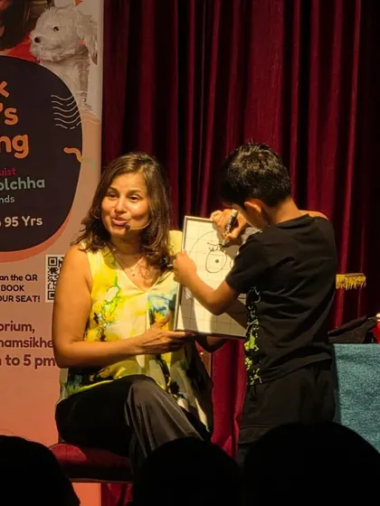 I love it when kids get to be part of the act. Here, a young volunteer helps me create a new character right on stage.