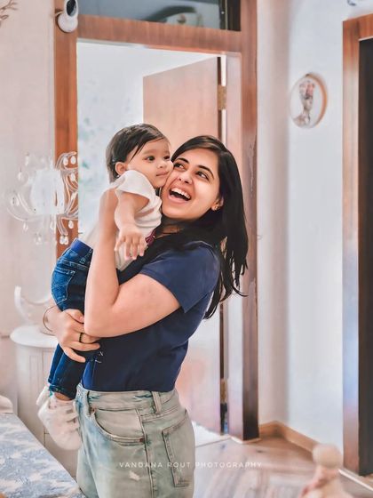 I love capturing simple, candid moments like this one. A mother's joyful laugh as she holds her baby at home creates a portrait that is authentic and full of happiness.