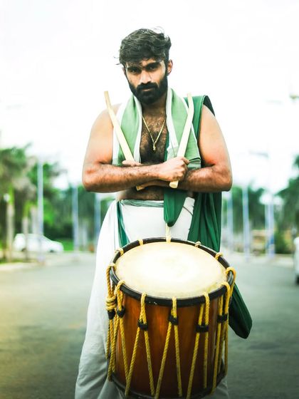 A strong stance with the Chenda. This portrait reflects the confidence and readiness of our performers.
