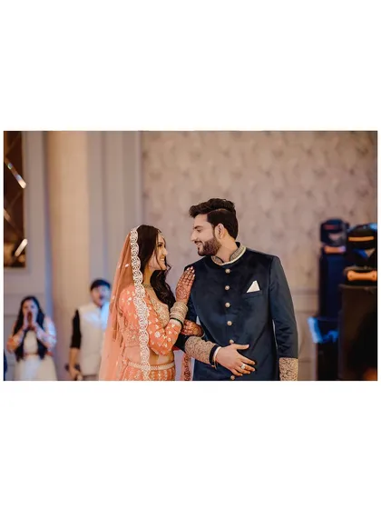 A candid moment of the couple sharing a look of love as they walk through their engagement party. Capturing these in-between moments is essential for telling the full story.