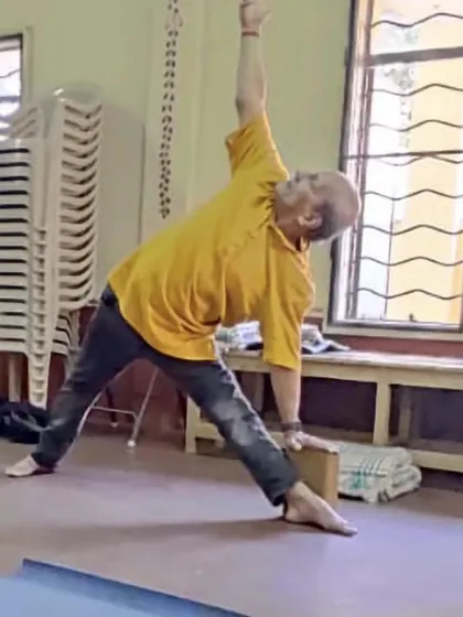 Trikonasana (Triangle Pose) with a block.