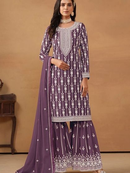 A regal purple salwar kameez with intricate white thread embroidery. The georgette fabric gives it a beautiful flow, making you feel like a queen.