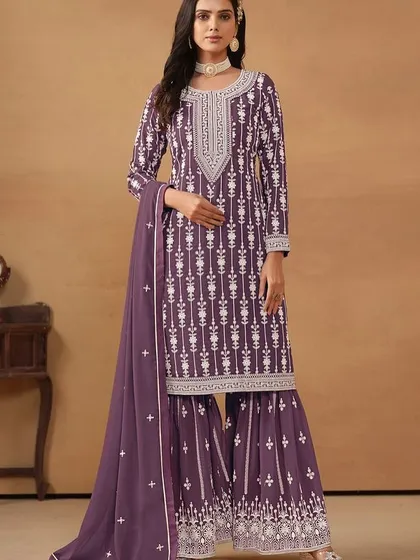 A regal purple salwar kameez with intricate white thread embroidery. The georgette fabric gives it a beautiful flow, making you feel like a queen.