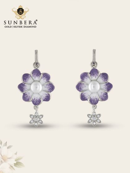 These lovely silver earrings feature a purple and white enamel flower with a dangling star charm. They are a whimsical and elegant choice for any occasion.