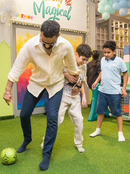 Why should kids have all the fun? We love it when parents join in, like this dad showing off his soccer skills with the boys.