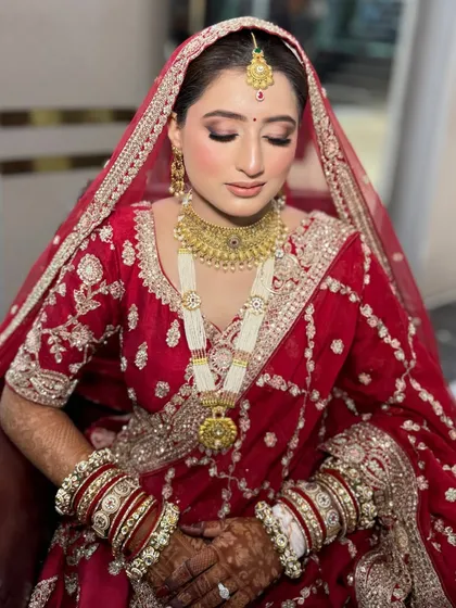 A beautiful close-up showing the bride's soft, shimmery eye makeup and perfectly matched lip color. The entire look is elegant and timeless.