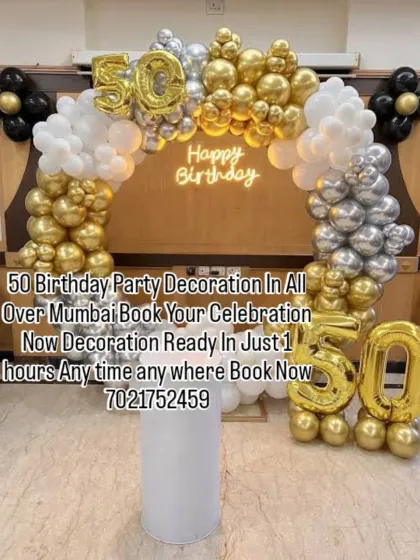 Celebrating 50 years in style with this gold, silver, and black balloon arch. The large foil numbers and neon "Happy Birthday" sign make this a perfect setup for a milestone celebration.
