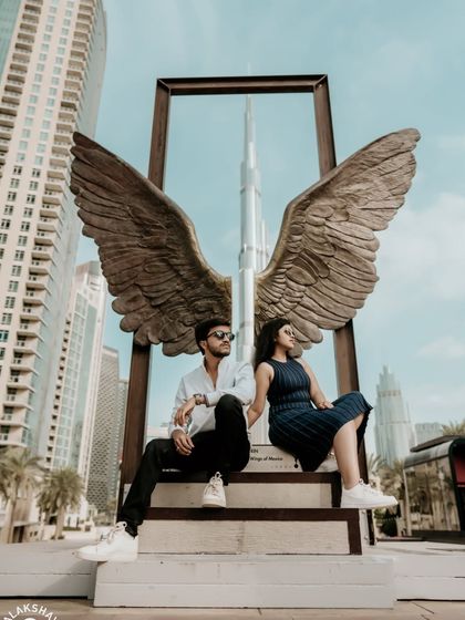 A creative and iconic pre-wedding shot at the Wings of Mexico sculpture with the Burj Khalifa perfectly framed. This is a must-have photo for any Dubai love story.