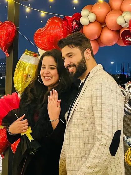 Capturing the pure joy right after she said yes. The smiles, the ring, and the celebratory backdrop of balloons and lights make for a perfect engagement photo.