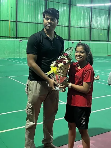 A student presenting a bouquet during our 4th-anniversary celebration. The support from our players and their families is the backbone of our academy.