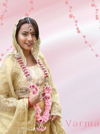 A beautiful varmala is a wedding essential. This image features a bride-to-be wearing an elegant pink and white floral garland, perfect for an engagement or roka ceremony.