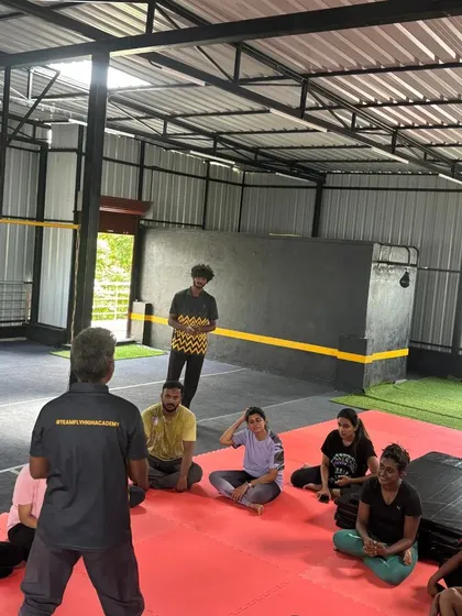 A shot from our gymnastics workshop, where I explain techniques to a group of engaged adult learners.