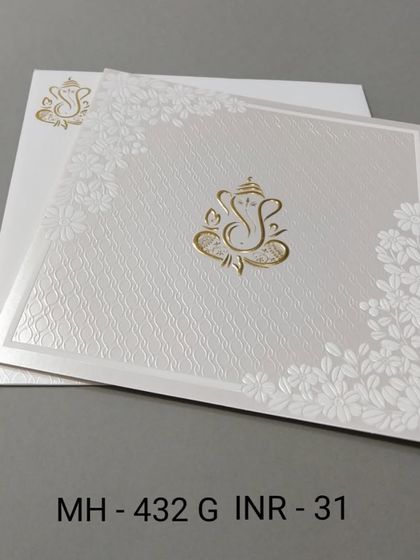 A clean and simple white invitation with a gold Ganesha motif. The textured paper and floral corners add a touch of elegance to this budget-friendly card.