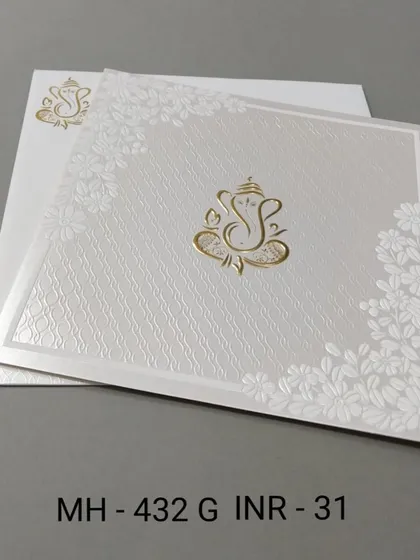A clean and simple white invitation with a gold Ganesha motif. The textured paper and floral corners add a touch of elegance to this budget-friendly card.