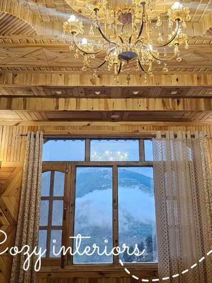 The interiors are designed to feel like a warm embrace, with intricate woodwork done by local artisans. This is a look inside one of the rooms, where you can see the valley right from your window.