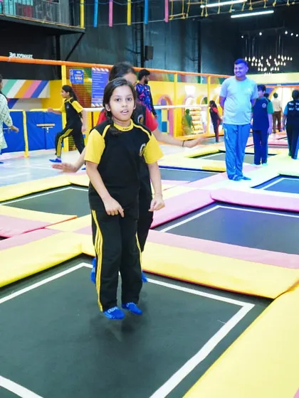 A student mid-jump, enjoying the freedom and fun of our trampoline park during a school outing.